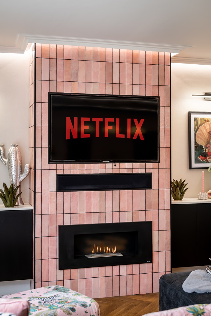 Pink tiled chimney breast with tv and fire place